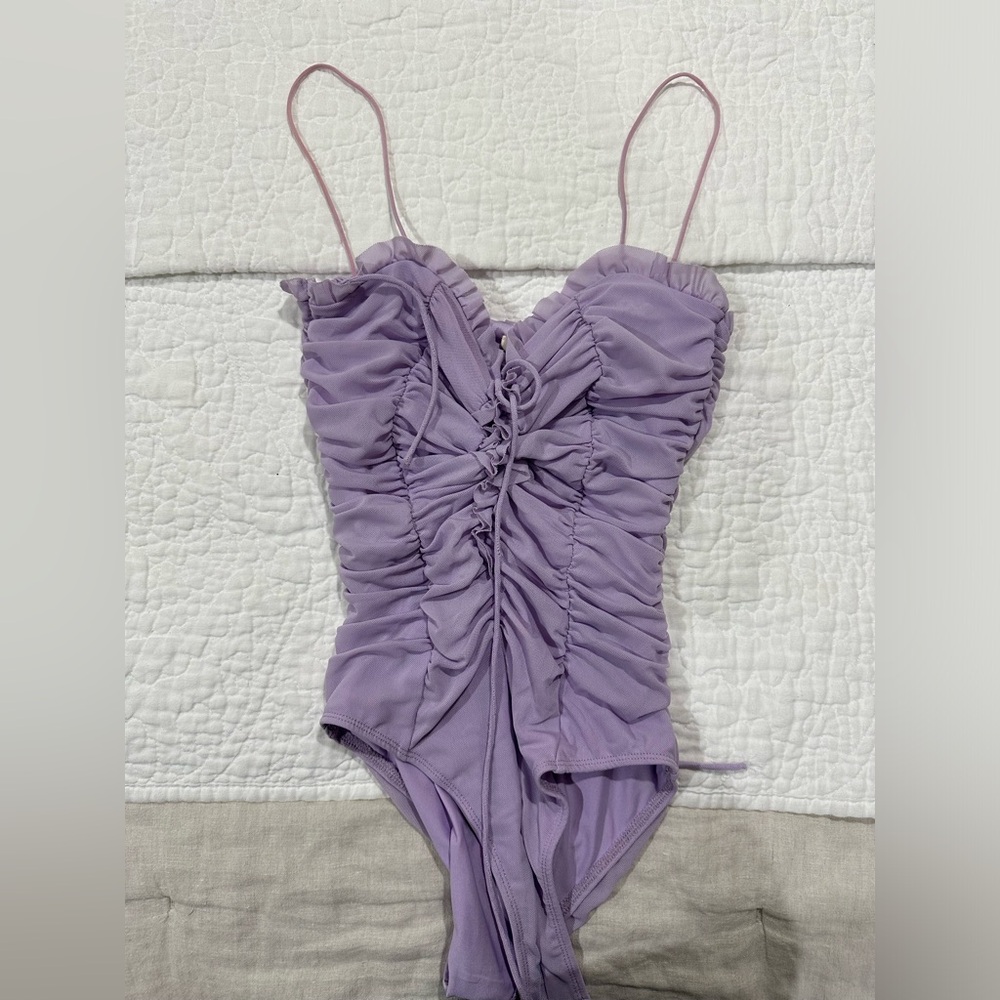 Purple body suit with tie in the middle
